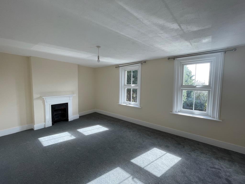 Lot: 111 - WELL PRESENTED MID-TERRACE HOUSE - Bedroom with grey carpet, white walls and victorian fireplace